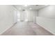 Bright open loft area featuring neutral carpeting, ample space, and abundant natural light at 7509 Oak Spring Ln, Davenport, FL 33837