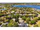Stunning aerial view of a lakeside home with lush landscaping in a desirable neighborhood at 8424 Lake Burden Cir, Windermere, FL 34786