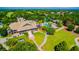 Aerial shot of the community clubhouse, pool, and tennis courts surrounded by lush greenery at 8424 Lake Burden Cir, Windermere, FL 34786