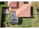 Aerial view of a home with a screened pool and a cozy outdoor fire pit area at 8424 Lake Burden Cir, Windermere, FL 34786