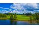 Scenic aerial view of a lush golf course community with a beautiful lake at 8424 Lake Burden Cir, Windermere, FL 34786