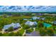 Scenic aerial view of community with lush landscaping, lake, and recreational facilities at 8424 Lake Burden Cir, Windermere, FL 34786