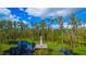 Aerial view of a wooden boardwalk and platform surrounded by lush trees in a serene water area at 8424 Lake Burden Cir, Windermere, FL 34786