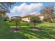 View of the backyard showing the lawn, patio, and surrounding homes at 8424 Lake Burden Cir, Windermere, FL 34786