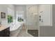 Elegant bathroom featuring a soaking tub, a walk-in shower, and tiled flooring at 8424 Lake Burden Cir, Windermere, FL 34786