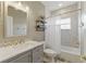 Modern bathroom with patterned tile accents, a framed mirror, and a shower with a curtain at 8424 Lake Burden Cir, Windermere, FL 34786