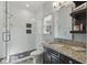 Modern bathroom featuring a glass-enclosed shower, and updated vanity with granite countertop at 8424 Lake Burden Cir, Windermere, FL 34786