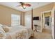 This bedroom features a four-poster bed, neutral walls, and access to an additional room at 8424 Lake Burden Cir, Windermere, FL 34786