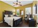 Comfortable bedroom featuring dark wood furniture, ceiling fan, and bright natural light at 8424 Lake Burden Cir, Windermere, FL 34786