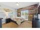 Bedroom featuring unique wood wall paneling and a nature-themed mural at 8424 Lake Burden Cir, Windermere, FL 34786