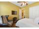 Cozy bedroom showcasing a decorative chair, built-in closet, and mounted television at 8424 Lake Burden Cir, Windermere, FL 34786