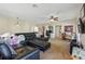 Spacious bonus room with large sofa, ceiling fan, built-ins, and television at 8424 Lake Burden Cir, Windermere, FL 34786