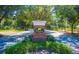 The Golden Bear Club community entrance with brick signage, mature trees, and well-kept landscaping at 8424 Lake Burden Cir, Windermere, FL 34786