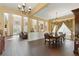Elegant dining room featuring tile floors, chandelier, and ample natural light from windows and French doors at 8424 Lake Burden Cir, Windermere, FL 34786