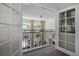 Hallway with views to the floor below through a decorative railing and French doors at 8424 Lake Burden Cir, Windermere, FL 34786