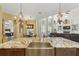 Gourmet kitchen boasts granite countertops, stainless steel sink, and elegant lighting fixtures at 8424 Lake Burden Cir, Windermere, FL 34786