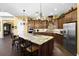 Modern kitchen with granite countertops, wooden cabinets, and stainless steel appliances at 8424 Lake Burden Cir, Windermere, FL 34786
