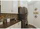 Well-organized laundry room with washer, dryer, cabinets, and tiled backsplash at 8424 Lake Burden Cir, Windermere, FL 34786