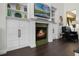 Living room featuring a fireplace with built in shelves and a view of the fire at 8424 Lake Burden Cir, Windermere, FL 34786
