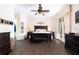 Spacious main bedroom featuring a ceiling fan, dark wood furniture, and a doorway to a walk-in closet at 8424 Lake Burden Cir, Windermere, FL 34786