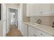Pantry with white cabinetry, a mini-refrigerator, ample counter space, and storage at 8424 Lake Burden Cir, Windermere, FL 34786