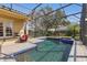 Inviting screened-in pool area with spa, brick pavers, and comfortable outdoor seating at 8424 Lake Burden Cir, Windermere, FL 34786