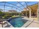 Backyard pool with screened enclosure, patio, and outdoor kitchen space for entertaining at 8424 Lake Burden Cir, Windermere, FL 34786