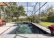 A luxurious screened-in pool with lush landscaping offers a private retreat at 8424 Lake Burden Cir, Windermere, FL 34786