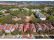 Aerial view of a multi-Gathering residential neighborhood featuring townhomes with red-tile roofs and mature trees at 8961 Cuban Palm Rd, Kissimmee, FL 34747