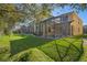 Large, grassy backyard with a screened-in patio and pool area, ideal for outdoor living at 8961 Cuban Palm Rd, Kissimmee, FL 34747