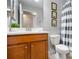 The cozy bathroom features a striped shower curtain, bright lighting, and Minion-themed decorations at 8961 Cuban Palm Rd, Kissimmee, FL 34747