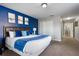 Spacious bedroom with blue accent wall, featuring a king bed and carpet flooring at 8961 Cuban Palm Rd, Kissimmee, FL 34747