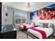 Bright bedroom features dual twin beds, stylish Star Wars themed decor, and a large window at 8961 Cuban Palm Rd, Kissimmee, FL 34747