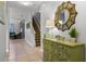 Welcoming foyer with tiled floors, an ornate mirror and a view of the staircase leading to the upper level at 8961 Cuban Palm Rd, Kissimmee, FL 34747
