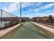 Community shuffleboard court with view of well-kept landscaping, community buildings and attractive blue skies at 8961 Cuban Palm Rd, Kissimmee, FL 34747