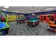 Bright, spacious community game room with a variety of games, tables, and themed decorations at 8961 Cuban Palm Rd, Kissimmee, FL 34747