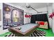 Unique garage conversion to a game room featuring a billiards table and whimsical Wonderland themed decor at 8961 Cuban Palm Rd, Kissimmee, FL 34747