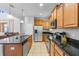 Well-equipped kitchen with stainless steel appliances, granite countertops, and a view into the adjacent living area at 8961 Cuban Palm Rd, Kissimmee, FL 34747