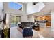 Open-concept living space boasts soaring ceilings, a modern kitchen, and seamless access to an outdoor patio at 8961 Cuban Palm Rd, Kissimmee, FL 34747