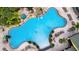 Aerial view of the outdoor community pool featuring ample space for swimming and relaxing under the sunny sky at 8961 Cuban Palm Rd, Kissimmee, FL 34747