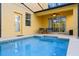 Refreshing pool with a covered patio area, perfect for relaxation and outdoor entertainment at 8961 Cuban Palm Rd, Kissimmee, FL 34747