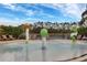 Fun splash pad featuring colorful water features and lounge chairs for relaxing by the water under a sunny sky at 8961 Cuban Palm Rd, Kissimmee, FL 34747