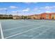 Well-maintained tennis court surrounded by community townhomes, ready for a friendly match under the sun at 8961 Cuban Palm Rd, Kissimmee, FL 34747