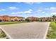 A bright volleyball court is ready for a sunny day game, surrounded by townhomes and lush greenery at 8961 Cuban Palm Rd, Kissimmee, FL 34747