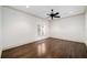 Bright bedroom features hardwood flooring, white walls, crown molding, and modern ceiling fan at 900 S Lake Adair Blvd, Orlando, FL 32804