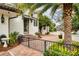 Charming front entrance with landscaped yard, wrought iron fence, tiled patio, and lush greenery at 900 S Lake Adair Blvd, Orlando, FL 32804