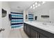 Bathroom featuring a double vanity, tile floors, decorative wall art and a striped shower curtain at 9192 Bradleigh Dr, Winter Garden, FL 34787
