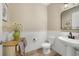 Cozy half bath with shiplap, pedestal sink, wood-look floors, and a decorative wood cabinet at 9192 Bradleigh Dr, Winter Garden, FL 34787