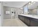 A well-lit primary bathroom with a double vanity, large mirror, and tiled floors at 9192 Bradleigh Dr, Winter Garden, FL 34787