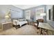 Charming bedroom with a daybed, neutral colors, and decor; with a large window and a comfortable chair at 9192 Bradleigh Dr, Winter Garden, FL 34787